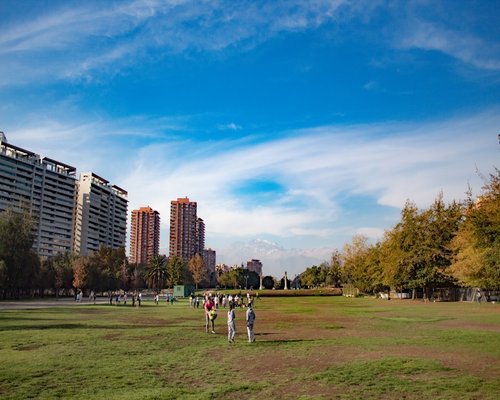 Group of friends talking and relaxing in an urban park in Chile enjoying an offline break
